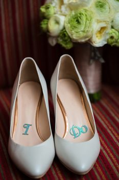 wedding shoes and wedding bouquet of white roses