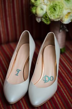 wedding shoes and wedding bouquet of white roses