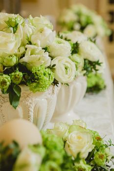 Wedding table decoration, wedding setting, wedding flowers on table, shallow depth of field.