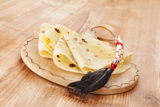 Crepes on wooden vintage kitchen board.