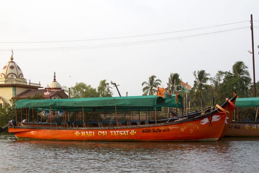 Old fishing boats are on the river bank. India, Goa.