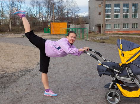 young woman is engaged in aerobics in a stadium combining a walk with baby