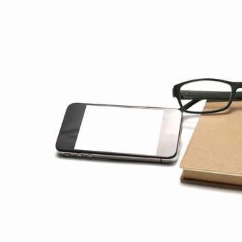 smart phone and eyeglasses with notebook isolated on white background