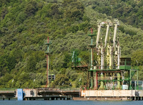 Gas and oil pump plant in sea shore, with green environment