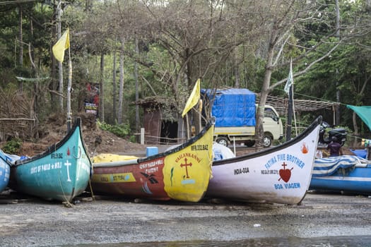 Old fishing boats are on the river bank. India, Goa.