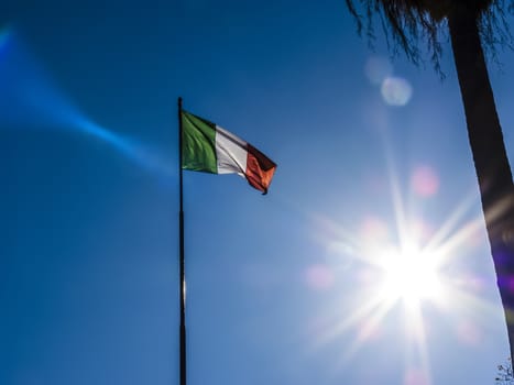 Italy flag with fabric structure against a sunny sky