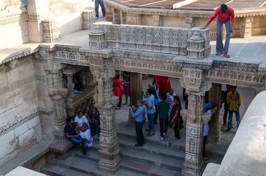 Ahmedabad, India - December 25, 2014: Indian People visit Adalaj Stepwell in Ahmedabad, Gujarat, India on December 25, 2014. The stepwell was built in 1499 by Muslim king Mohammed Begda for Queen Rani Roopba, wife of Veer Singh, the Vaghela chieftain.