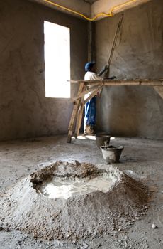 Masons are building walls plastered smooth.