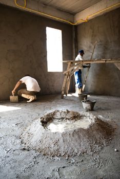 Masons are building walls plastered smooth.