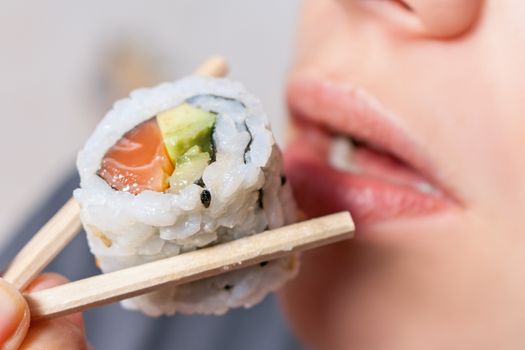 Close-up shot of a person who eats sushi