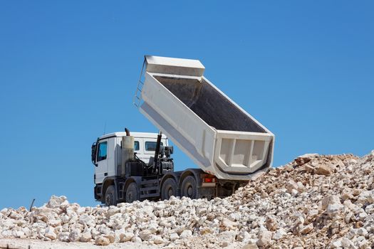 tipper truck unload crushed rocks