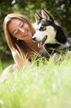 Young woman and her husky in the forest