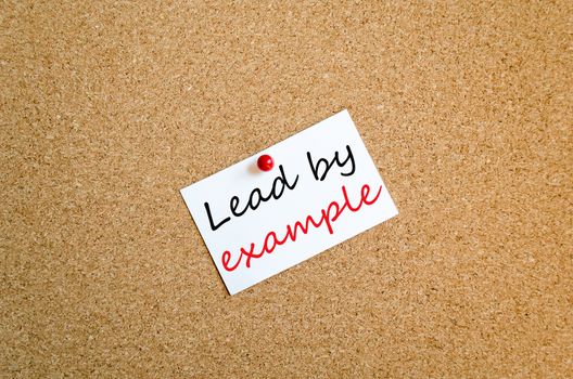 Sticky Note On Cork Board Background Lead by example concept
