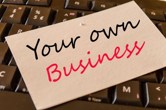 Your own business Concept on black keyboard
