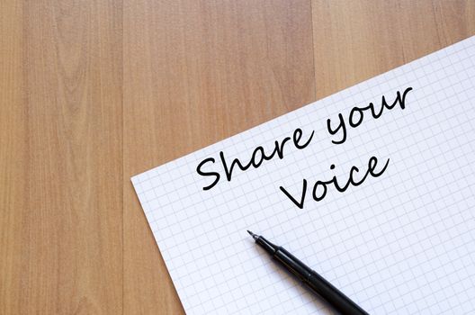 White blank notepad on office wooden table Share your voice concept
