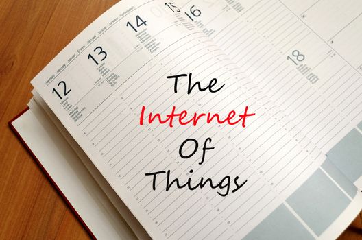 Business Notepad on wooden table The internet of things Concept Notepad