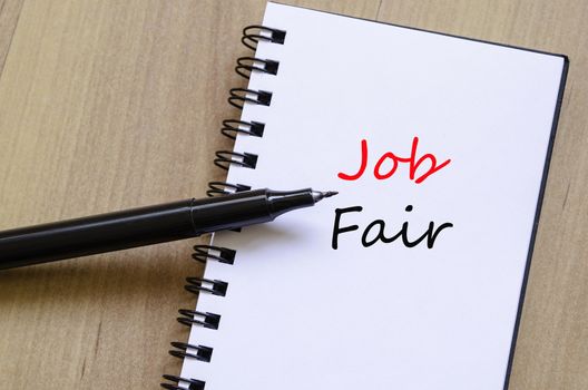 White notepad and ink pen on the wooden desk Job Fair Concept