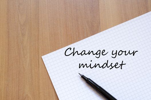 White blank notepad on office wooden table Change your mindset concept