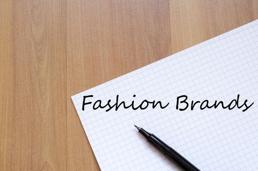 White blank notepad on office wooden table Fashion brands concept