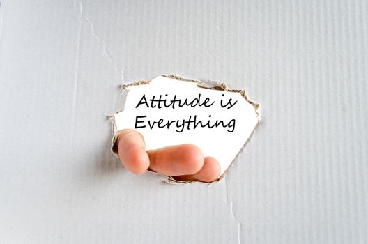 Hand and text on the cardboard background Attitude is Everything Concept