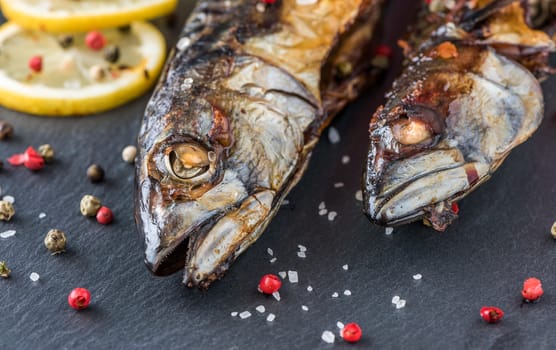 Baked Whole Mackerel Fish with Spice, Lemon and Rosemary on Stone