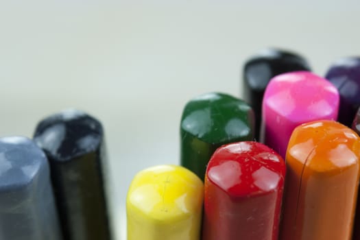 Close f of coloured pencils against a wooden background