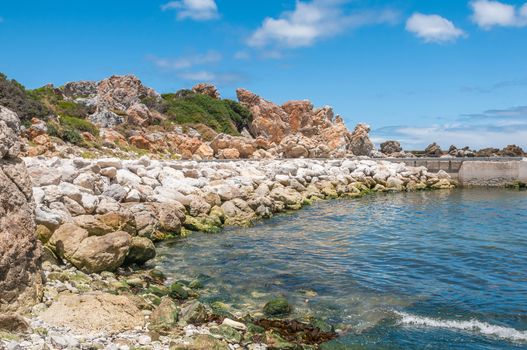 Multi-colored rocks and sea wall at the harbor in Kleinmond