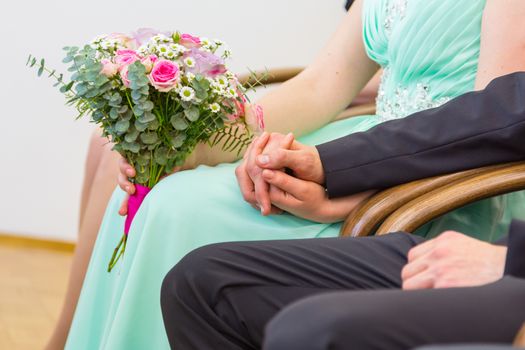 Bride and groom holding hands before the big moment. Wedding ceremony.