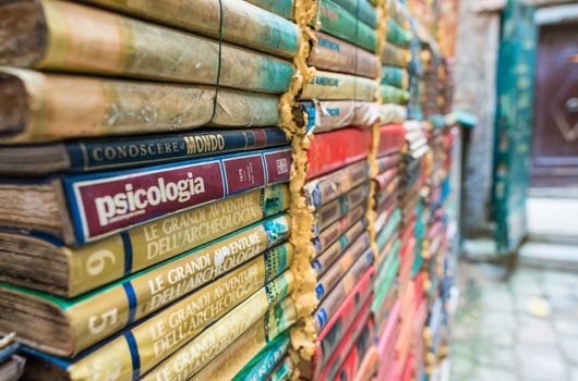 VENICE, ITALY - MAR 22, 2014: Old books of Acqua Alta bookstore. This is one of the most famous used bookstore in the world.