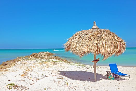 Grass umbrella at the beach on Aruba in the Caribbean