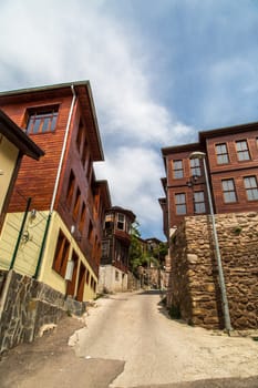 Old historical wooden buildings, Kapanca Street in Kocaeli on cloudy sky.