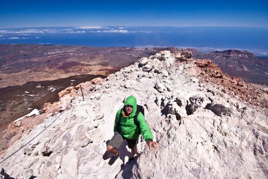 Man hiking. Young  guy hiking / backpacking in the rough  volcanic landscape on the volcano, Teide, highest peak of Spain.