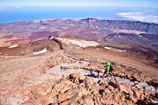 Man hiking. Young  guy hiking / backpacking in the rough  volcanic landscape on the volcano, Teide, highest peak of Spain.