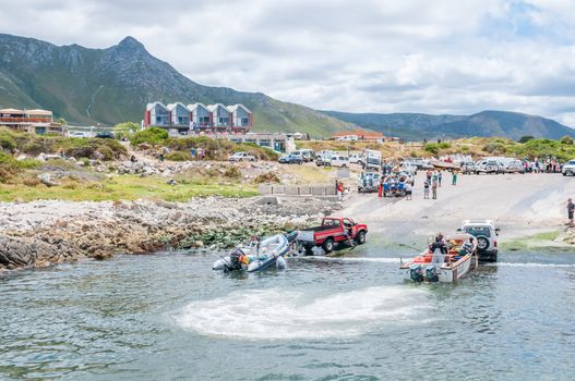 KLEINMOND, SOUTH AFRICA - DECEMBER 23, 2014: Crayfish boats being pulled with the days catch onto trailers at Kleinmond harbor