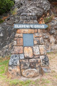 CAPE TOWN, SOUTH AFRICA - DECEMBER 23, 2014: Weathered memorial stone remembering the person after which Clarence Drive between Gordons Bay and Rooi Els was named