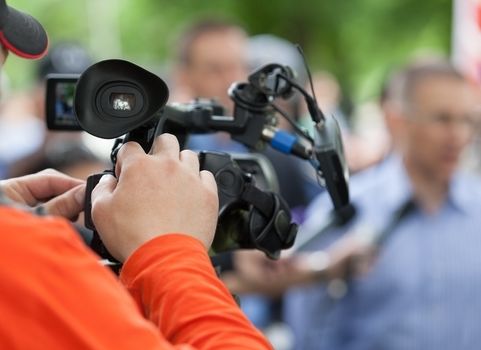 Filming an media event with a video camera