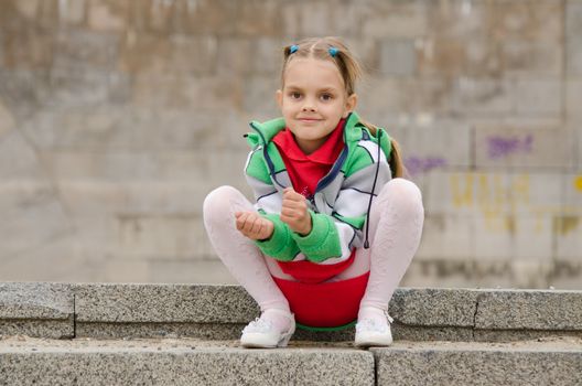 A girl of six years walking on the embankment