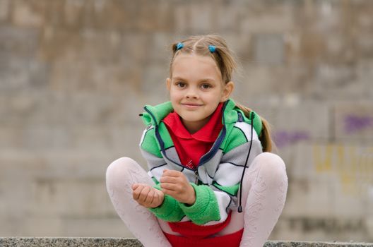 A girl of six years walking on the embankment
