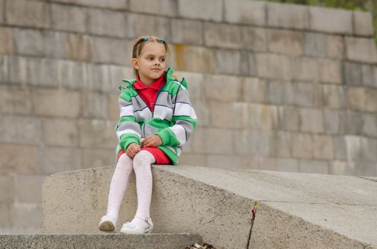A girl of six years walking on the embankment