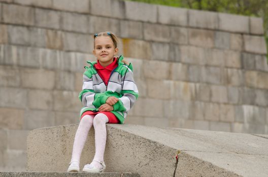 A girl of six years walking on the embankment