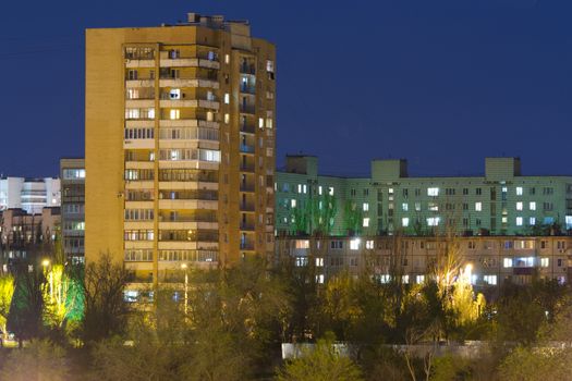 Night cityscape - high-rise building in the night sky and other high-rise buildings