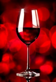 Glass of wine on a red background