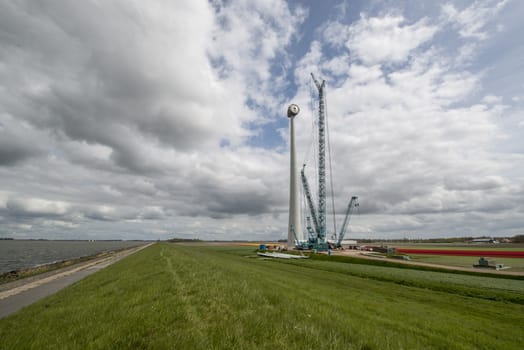 Construction of a modern windmill in the Noordoostpolder near the dyke of the IJsselmeer in Netherlands