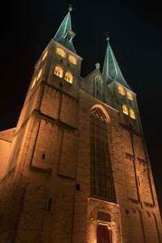 Illuminated church of the city of Deventer in the center of the Netherlands because of a special Char-les Dickens weekend. The Dutch place Deventer has annually at the end of the year around Christmas a dickens weekend. The old city centre is completely free of car traffic and the residents are his-torically dressed up