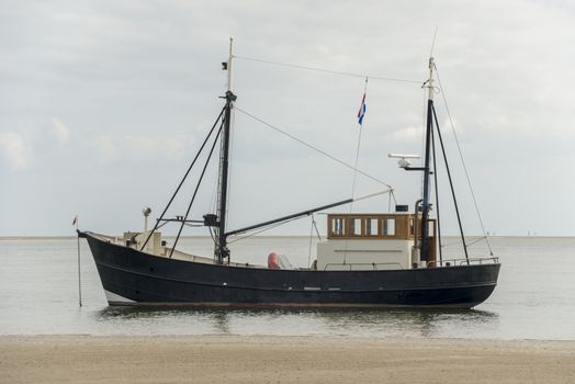 Fishing boat near the beach on the Dutch Wadden Sea