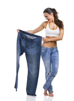 Woman with large jeans in dieting concept