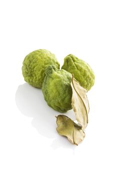 Delicious ripe bergamot fruit with dry leaves isolated on white background. Culinary healthy tropical fruit.