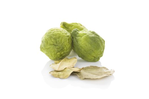 Delicious ripe bergamot fruit with dry leaves isolated on white background. Culinary healthy tropical fruit.