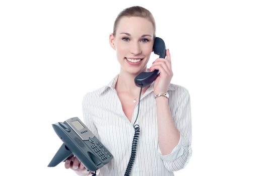 Happy female executive answering a phone call