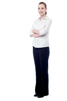 Full length of young business woman, folded arms.